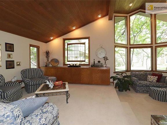 Two level living room with soaring wood ceiling & wall of windows!