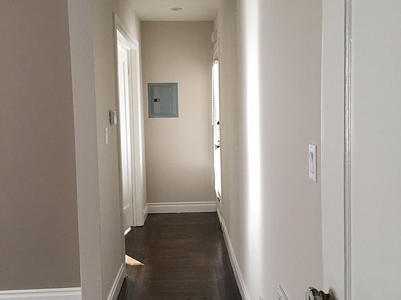 Hallway, entry door to the right. Bedroom across from entry door.