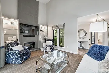 Custom drapery with black-out blinds, custom cabinetry, interior designed fireplace and finishes throughout home.