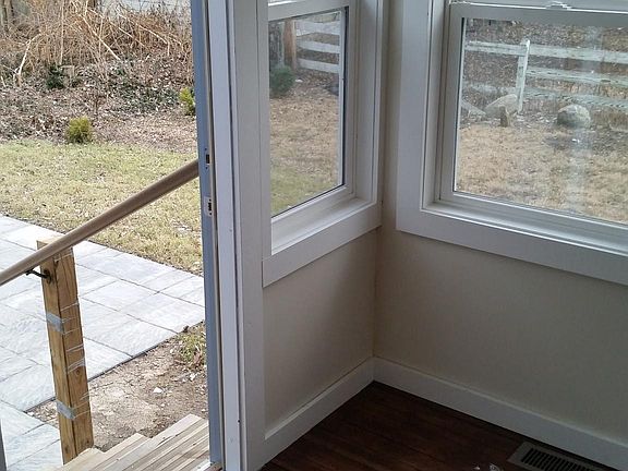 heated backporch opening to stone patio and backyard