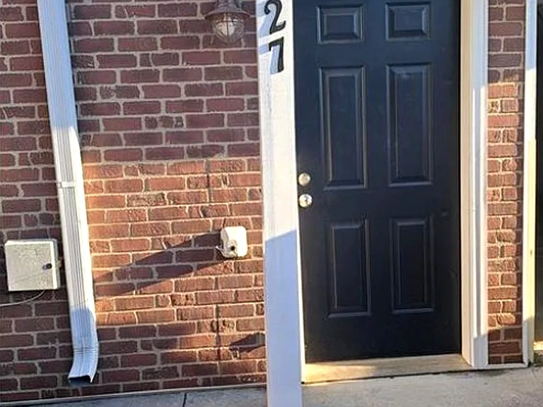 Welcoming front entrance with classic brick facade and covered entry.