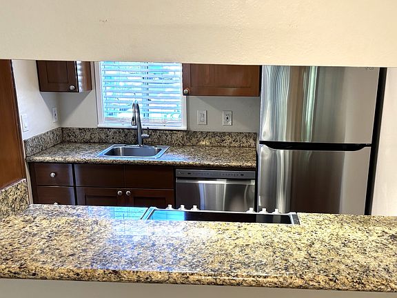 Looking through bar from living room to kitchen
