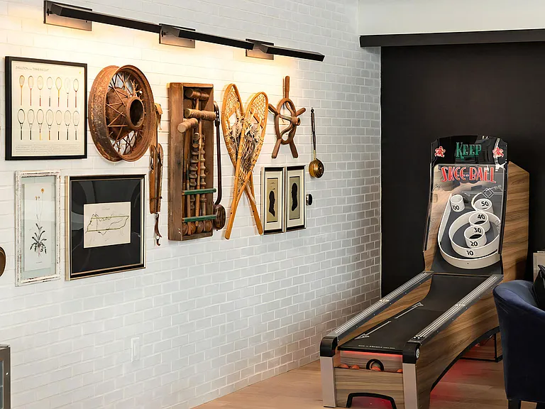 Vintage-Inspired Skee-Ball Game Station with Decorative Wall Art