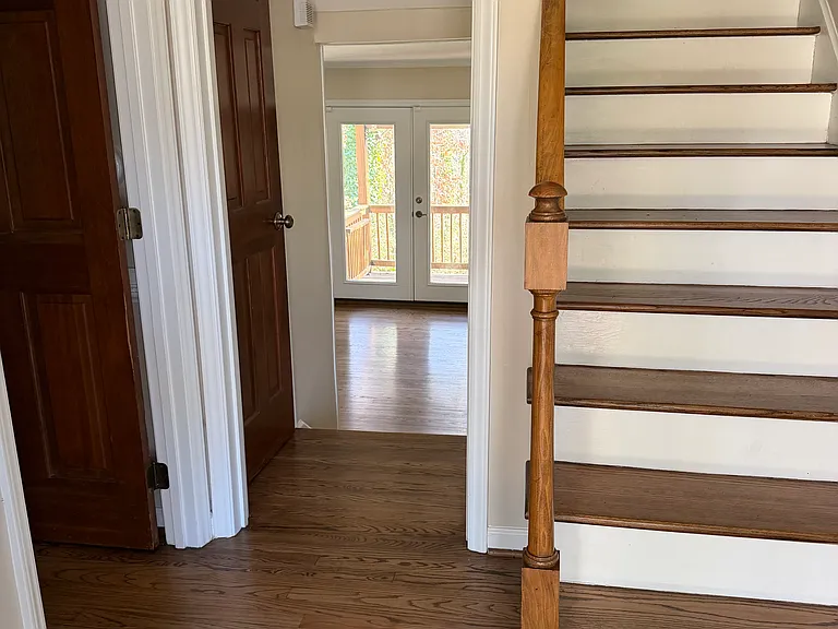 Foyer - view of 1st floor bedroom door, stair up to bedrooms, and stairs down to family room with french doors to rear deck.

Plus access to Kitchen, Laundry room, and Dining room / Home office.