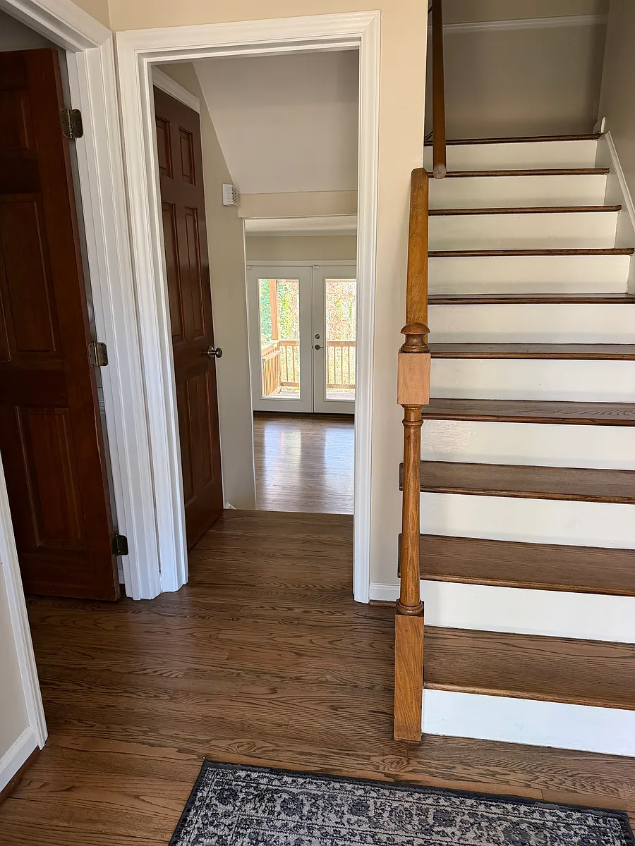 Foyer - view of 1st floor bedroom door, stair up to bedrooms, and stairs down to family room with french doors to rear deck.

Plus access to Kitchen, Laundry room, and Dining room / Home office. - 1003 Manchester Dr