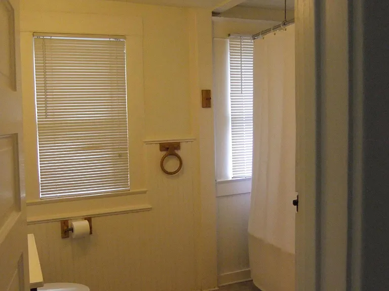 View of bathroom with claw foot tub and toilet and vanity sink