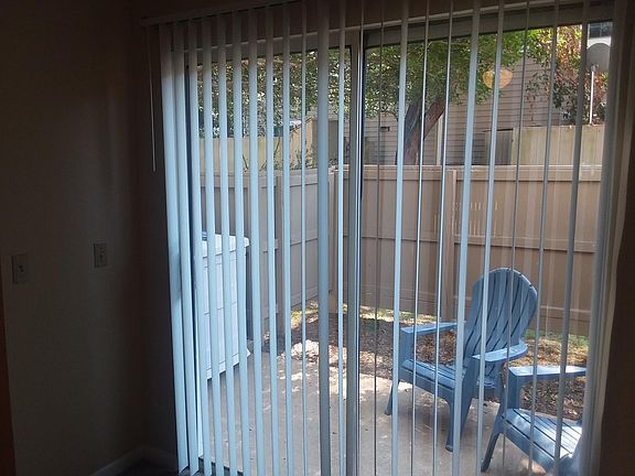 VIEW OF ENCLOSED PRIVATE PATIO AREA WITH STORAGE UNIT