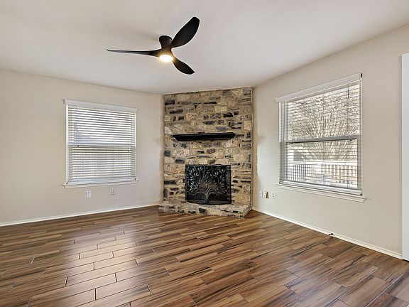 Living room with a new ceiling fan and fire place