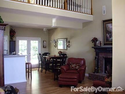 Great Room
						:
						View from front entrance, showing open plan into the Kitchen, with Loft above.