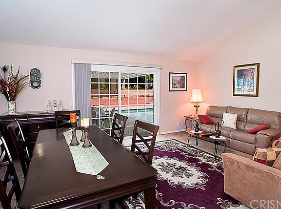 The spacious living room and dining area with vaul