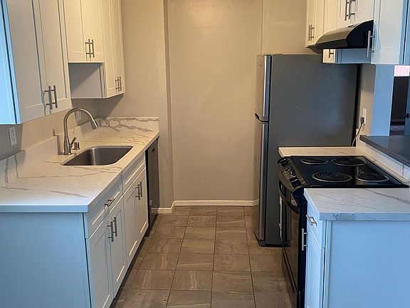 Kitchen - quartz counters, dishwasher, range, disposal, fridge