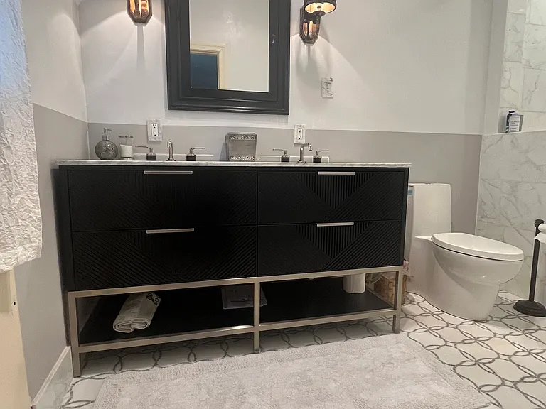 Primary bath marble-top DOUBLE sink vanity. Floor tile is mosaic marble.