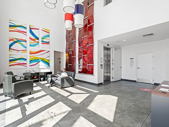 Bright and modern lobby with vibrant artwork and comfortable seating that welcomes you home in style.