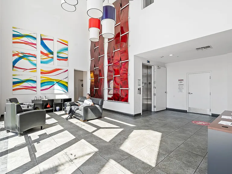 Bright and modern lobby with vibrant artwork and comfortable seating that welcomes you home in style.