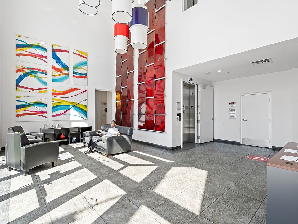 Bright and modern lobby with vibrant artwork and comfortable seating that welcomes you home in style.