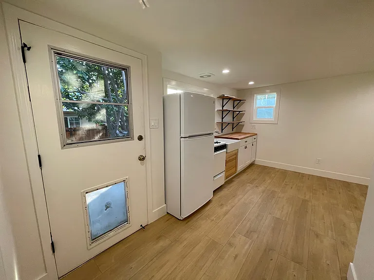 Entryway leading to kitchenette & living area