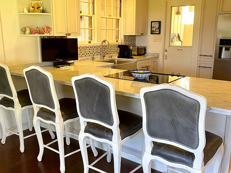 The spacious kitchen has stainless steel appliances, a bar top for convenient dining and a breakfast nook for more seating.