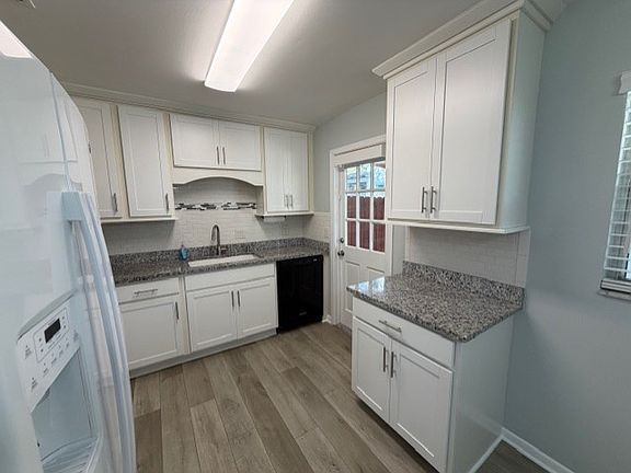 Diswasher and access to carport kitchen door on right behind front cabinet on right.
