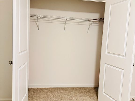 Furnished 2nd-floor bedroom with large closet.