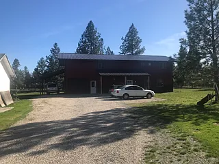 Looking at the front of the building, which shows the upstairs loft and the landlord's adjacent home