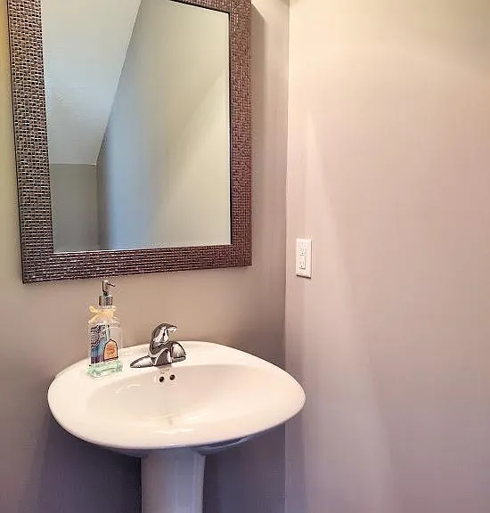 The half bathroom is located in the foyer area.