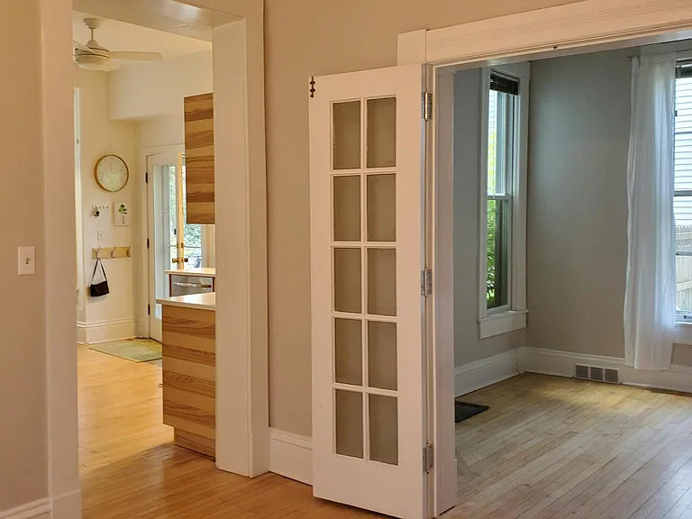 There is a bedroom (or den/office) adjacent to the dining room.