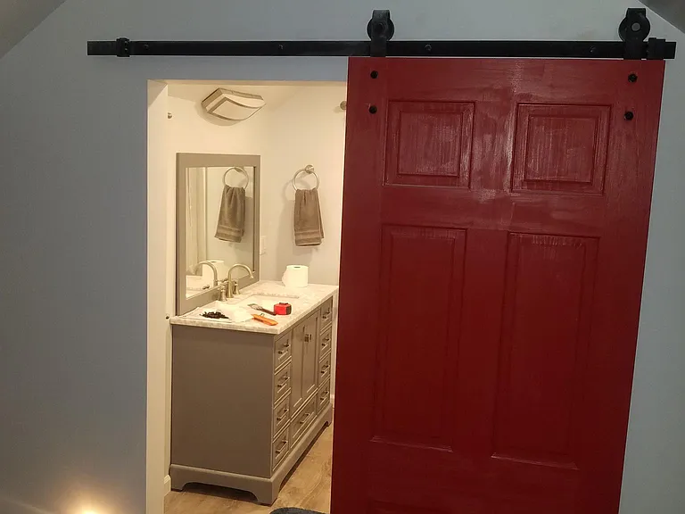 Barn door entrance to large bathroom
