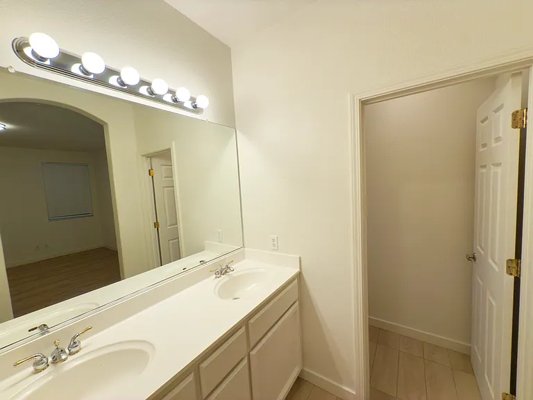 Private master toilet conveniently separated by a door for added privacy and functionality.