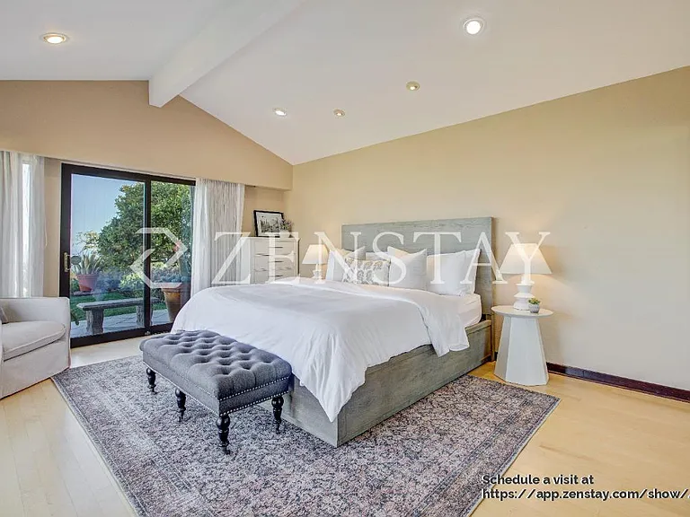 pacious primary bedroom with king bed and serene ambiance