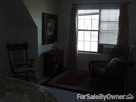 guest bedroom : large room with sitting area perfect for reading; large closet; overlooks pool;