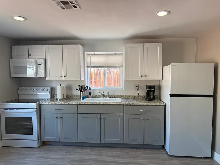 Full kitchen with modern cabinetry, full-size appliances, and ample counter space