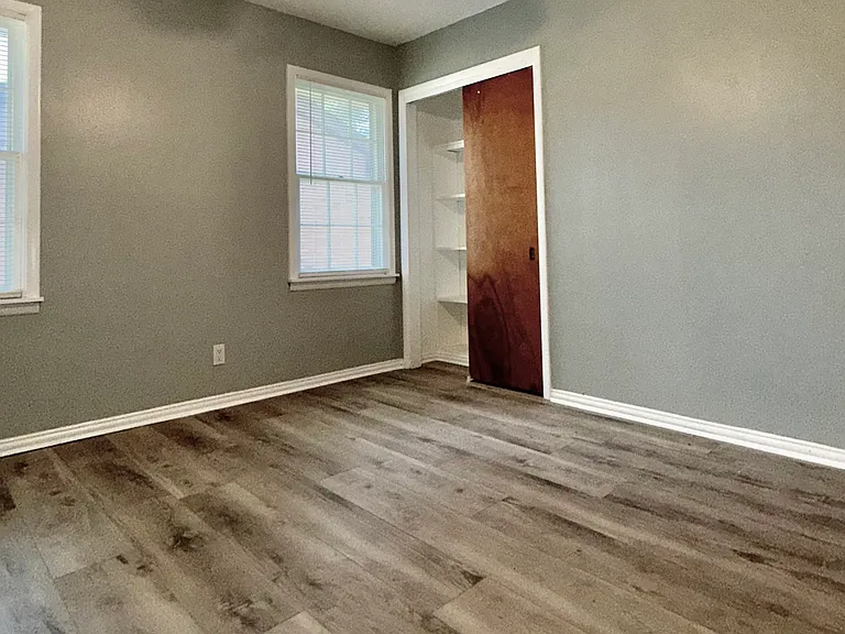 The 2nd bedroom and sliding double door closet facing the neighbor's house.