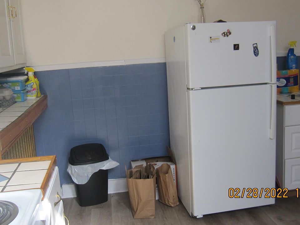 Back of kitchen showing Refrigerator, and counters