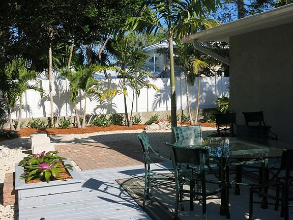 Wood deck, brick patio, planters, cut coral seating cubes