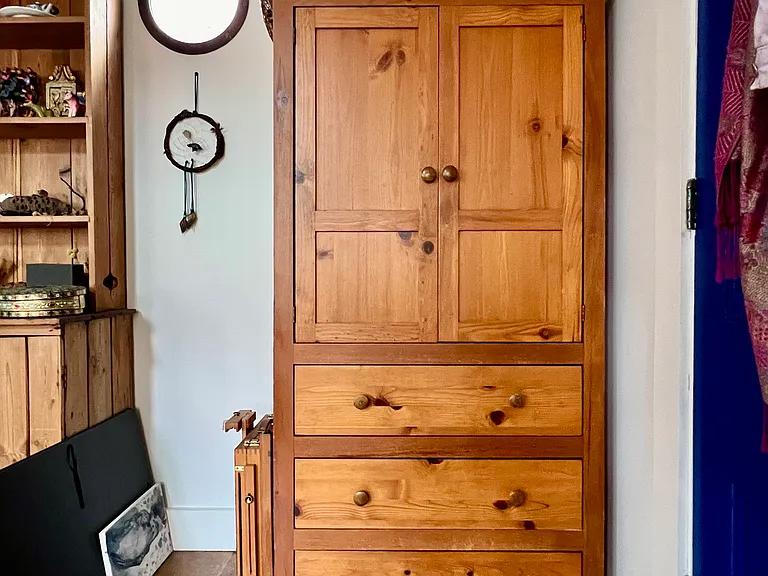 The space is furnished with dresser for hanging clothes and drawers.