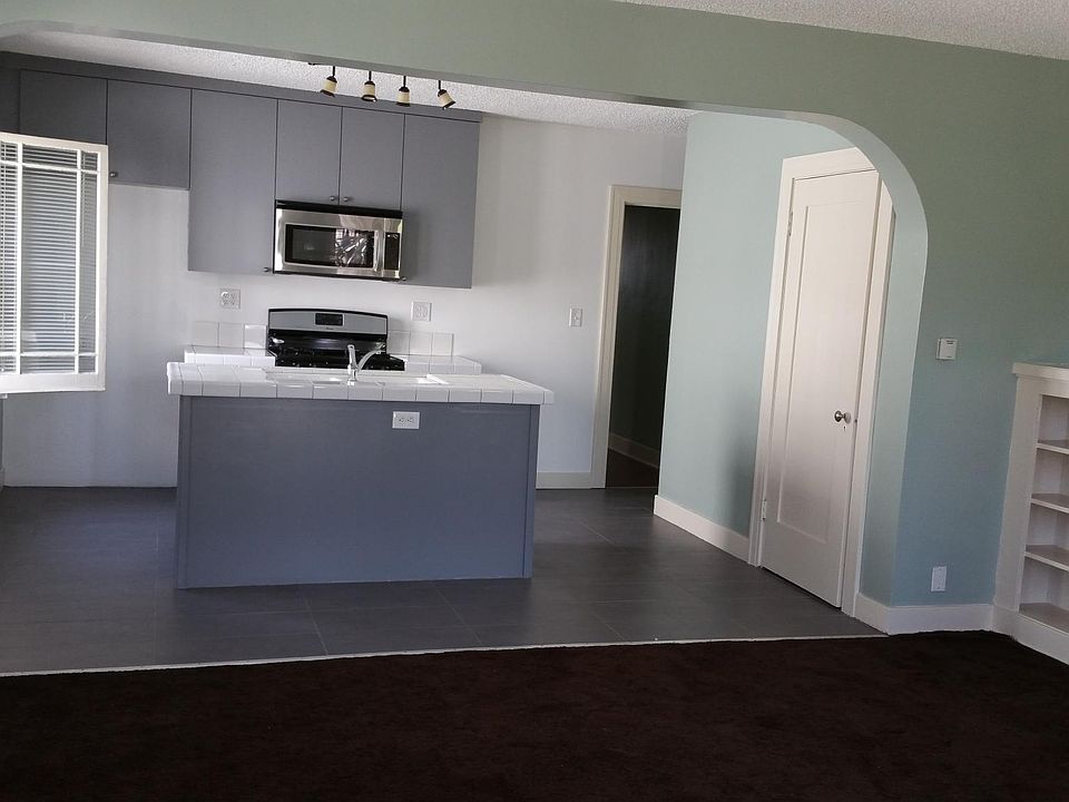 Kitchen includes stove, microwave, refrigerator (there but not shown) and hood vent.