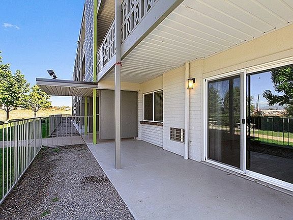 Inviting patio with modern railing, overlooking lush green surroundings, perfect for relaxation and outdoor activities.