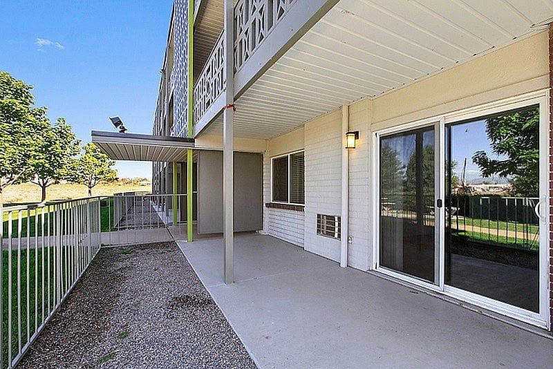 Inviting patio with modern railing, overlooking lush green surroundings, perfect for relaxation and outdoor activities.