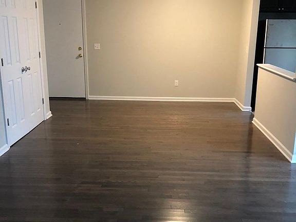 View of front door and partial view of closet space. This space can be used as a dining room area or just an open area.