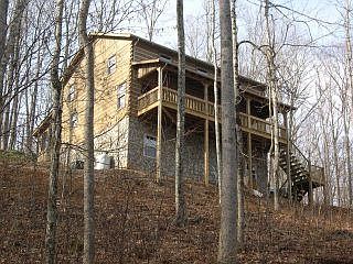 The large covered front deck is a perfect place to take in the views of the mountains and Laurel Creek.