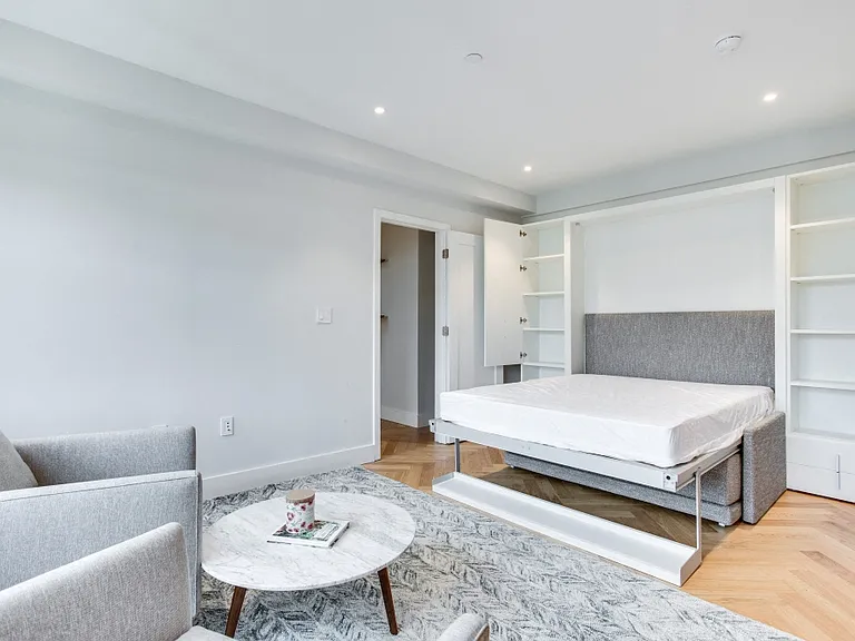 Furnished studio at the Century with murphy bed and extra bedside storage