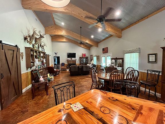 Living Room With Vaulted Ceiling Adjoining Kitchen