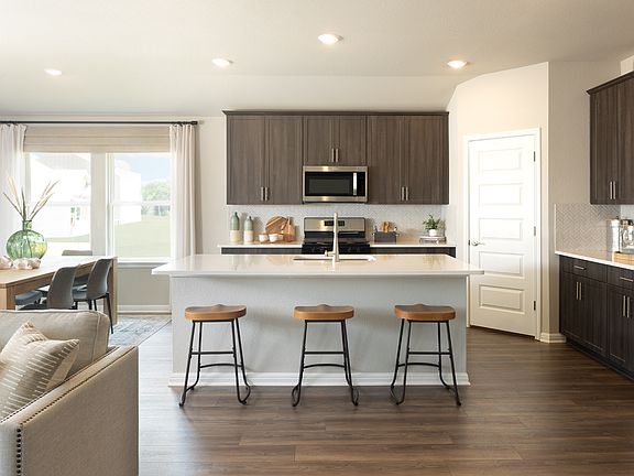 Our Lush design package features slate cabinets, off-white granite countertops, and EVP floorin