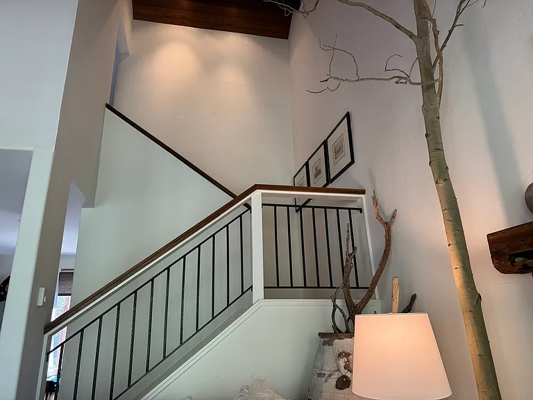 Stairs to the upstairs Primary suite with high cielings, generous closets and a full bath.