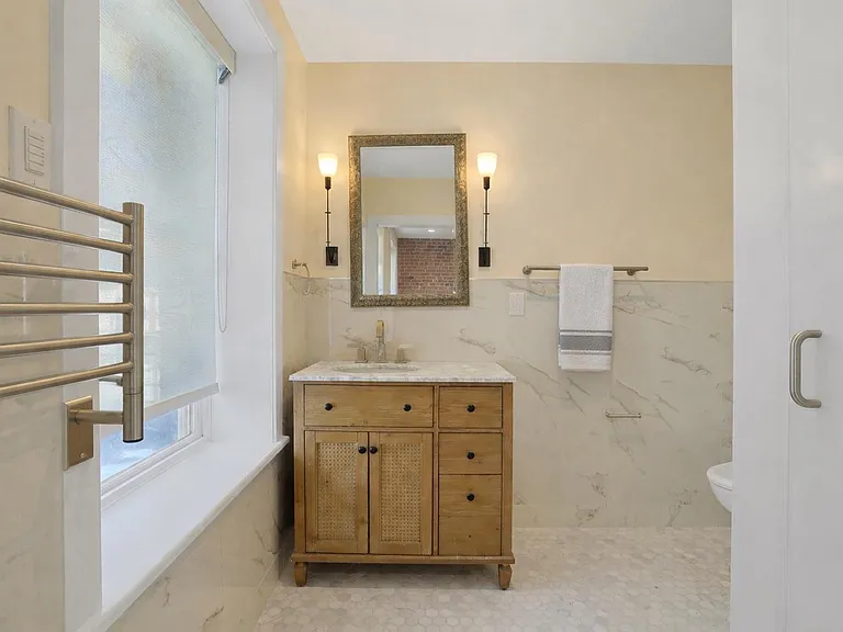 Bathroom: Sun-filled European-style en-suite bathroom with towel warmer.