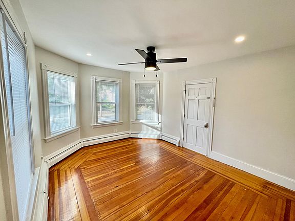 Living Room - Bay windows, recessed lighting, hardwood flooring