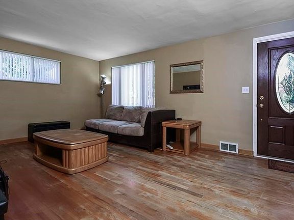 Living Room: Spacious living room with newer windows, marble window ledges and hardwood floor. Newer front door with leaded glass.