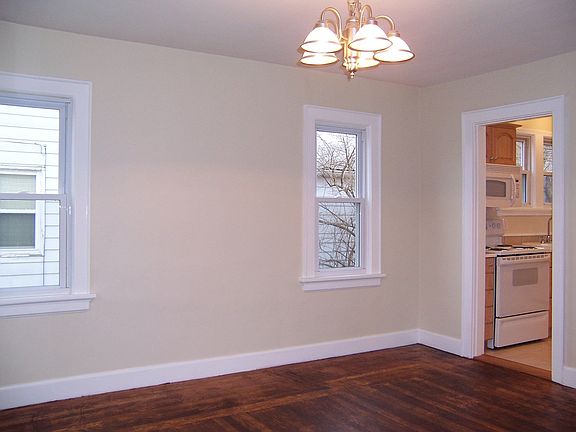 Dining room with many windows off of kitchen.