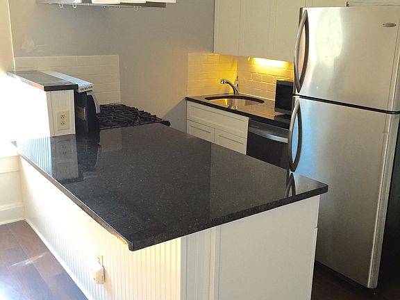 Newly remodeled kitchen with granite countertops, over hood, dishwasher and new cabinets