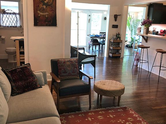 Living area looking toward the open kitchen and sunroom